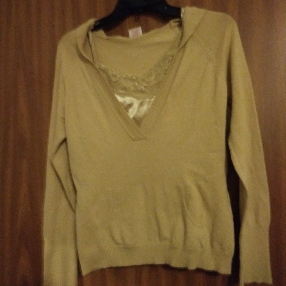 A tan sweater with a cami in underneath